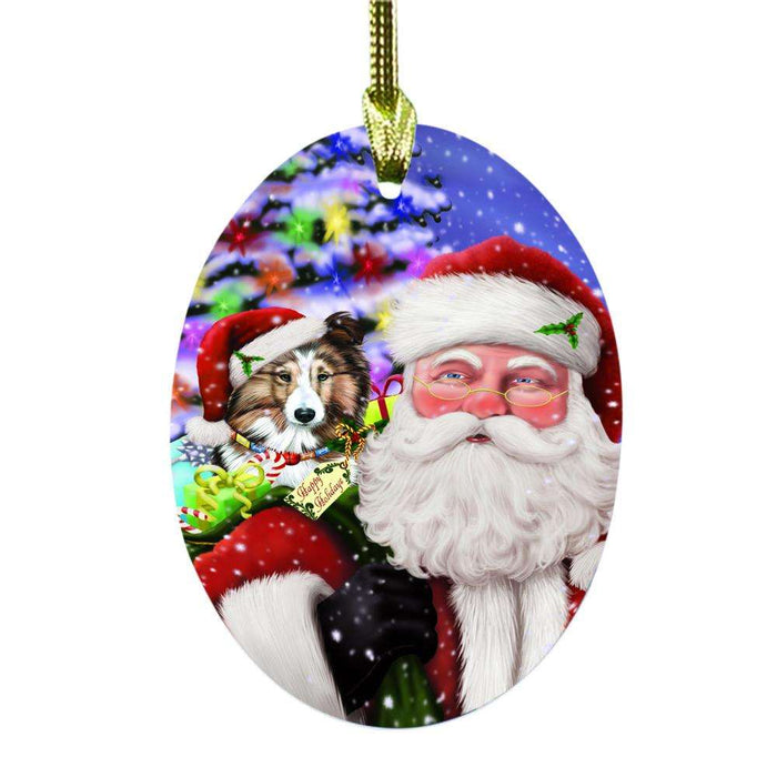 Jolly Old Saint Nick Santa Holding Shetland Sheepdog and Happy Holiday Gifts Oval Glass Christmas Ornament OGOR48885