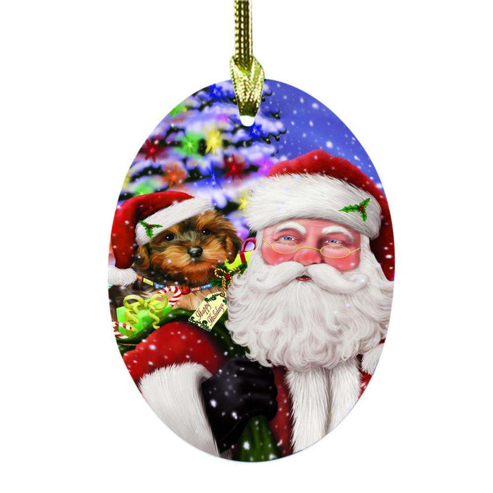 Jolly Old Saint Nick Santa Holding Yorkipoo Dog and Happy Holiday Gifts Oval Glass Christmas Ornament OGOR48902