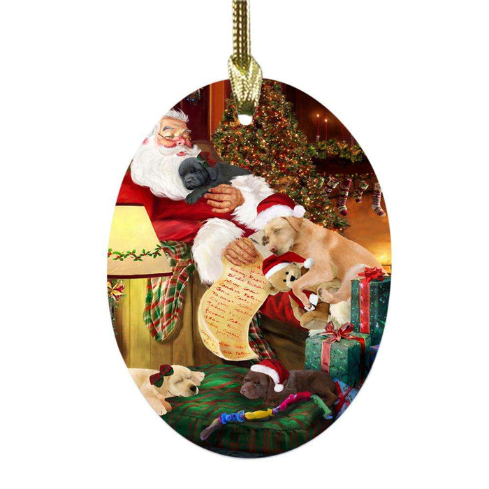 Labrador Retrievers Dog and Puppies Sleeping with Santa Oval Glass Christmas Ornament OGOR49292