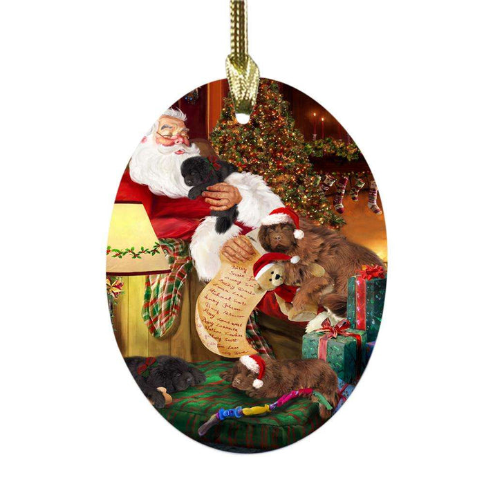Newfoundlands Dog and Puppies Sleeping with Santa Oval Glass Christmas Ornament OGOR49298