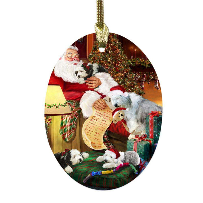 Old English Sheepdogs and Puppies Sleeping with Santa Oval Glass Christmas Ornament OGOR49300