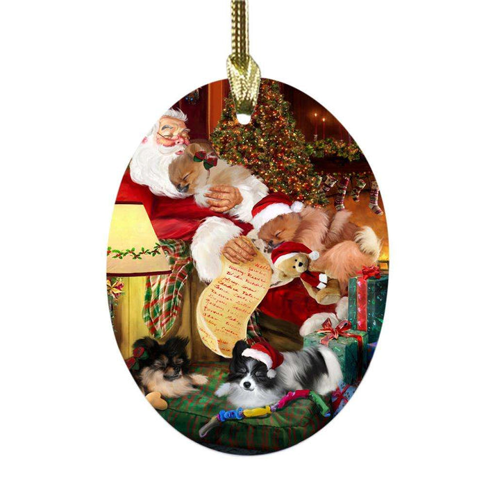 Pomeranians Dog and Puppies Sleeping with Santa Oval Glass Christmas Ornament OGOR49304