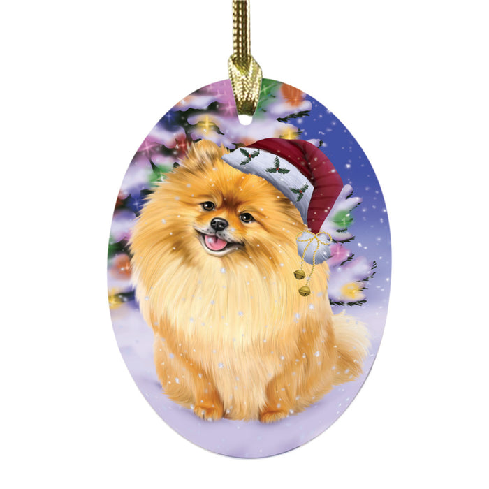 Winterland Wonderland Pomeranian Dog In Christmas Holiday Scenic Background Oval Glass Christmas Ornament OGOR49615