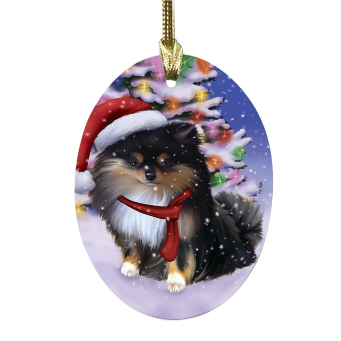 Winterland Wonderland Pomeranian Dog In Christmas Holiday Scenic Background Oval Glass Christmas Ornament OGOR49616