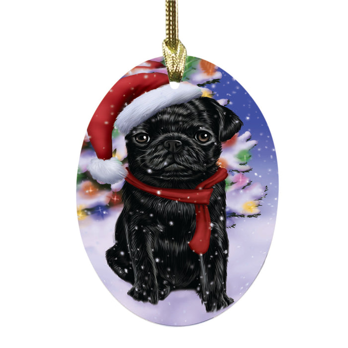 Winterland Wonderland Pug Dog In Christmas Holiday Scenic Background Oval Glass Christmas Ornament OGOR49620