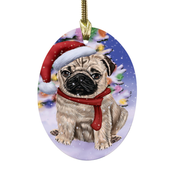 Winterland Wonderland Pug Dog In Christmas Holiday Scenic Background Oval Glass Christmas Ornament OGOR49621