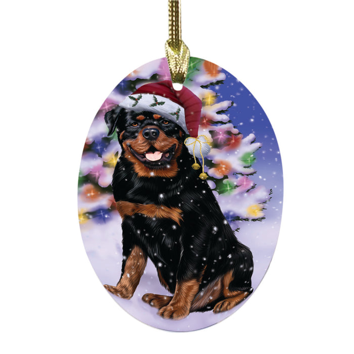 Winterland Wonderland Rottweiler Dog In Christmas Holiday Scenic Background Oval Glass Christmas Ornament OGOR49626