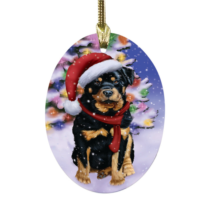 Winterland Wonderland Rottweiler Dog In Christmas Holiday Scenic Background Oval Glass Christmas Ornament OGOR49627