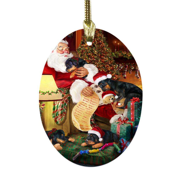 Rottweilers Dog and Puppies Sleeping with Santa Oval Glass Christmas Ornament OGOR49310