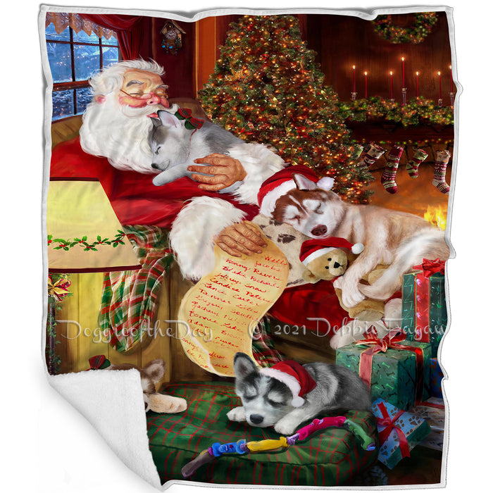 Siberian Husky Dog and Puppies Sleeping with Santa Blanket