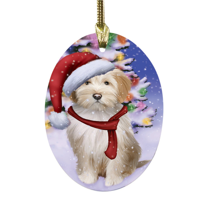 Winterland Wonderland Tibetan Terrier Dog In Christmas Holiday Scenic Background Oval Glass Christmas Ornament OGOR49650