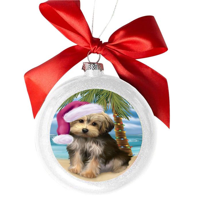 Summertime Happy Holidays Christmas Yorkipoo Dog on Tropical Island Beach White Round Ball Christmas Ornament WBSOR49413