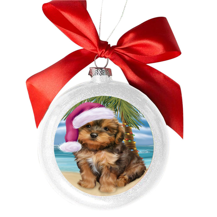 Summertime Happy Holidays Christmas Yorkipoo Dog on Tropical Island Beach White Round Ball Christmas Ornament WBSOR49414