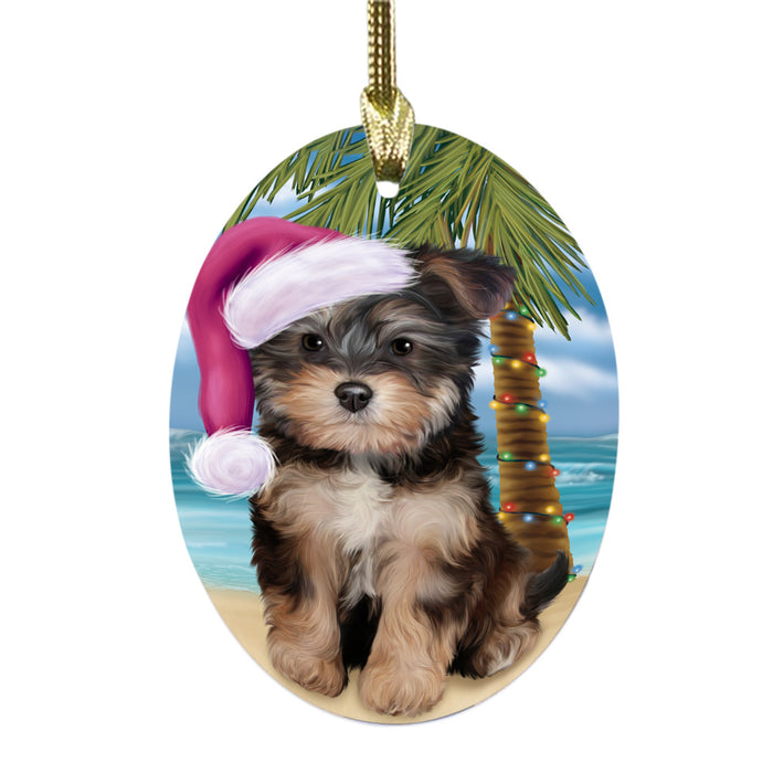 Summertime Happy Holidays Christmas Yorkipoo Dog on Tropical Island Beach Oval Glass Christmas Ornament OGOR49415