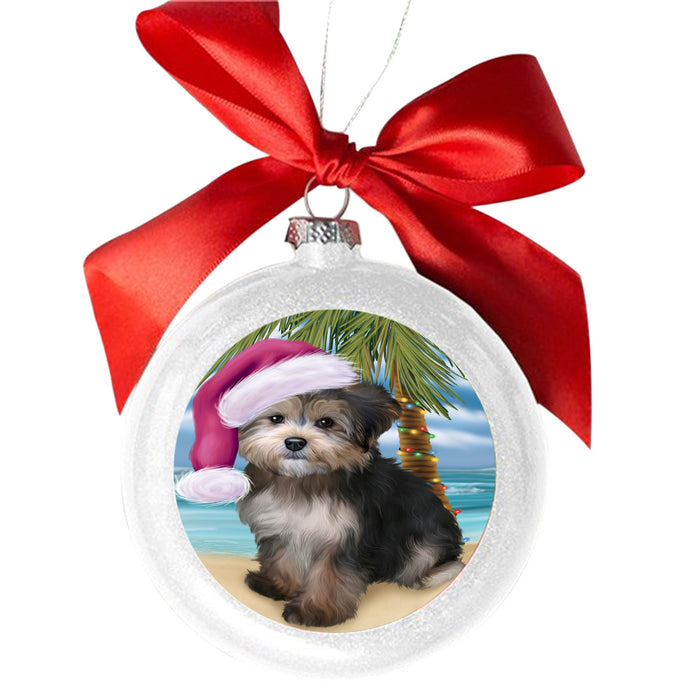 Summertime Happy Holidays Christmas Yorkipoo Dog on Tropical Island Beach White Round Ball Christmas Ornament WBSOR49416