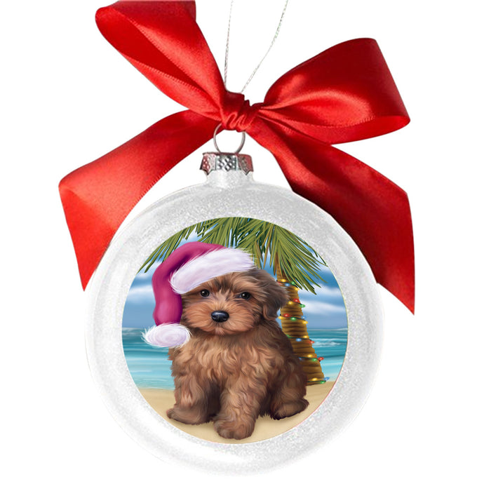 Summertime Happy Holidays Christmas Yorkipoo Dog on Tropical Island Beach White Round Ball Christmas Ornament WBSOR49417
